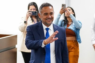 Nino de Enoque sorri e acena durante evento na Assembleia Legislativa de Pernambuco